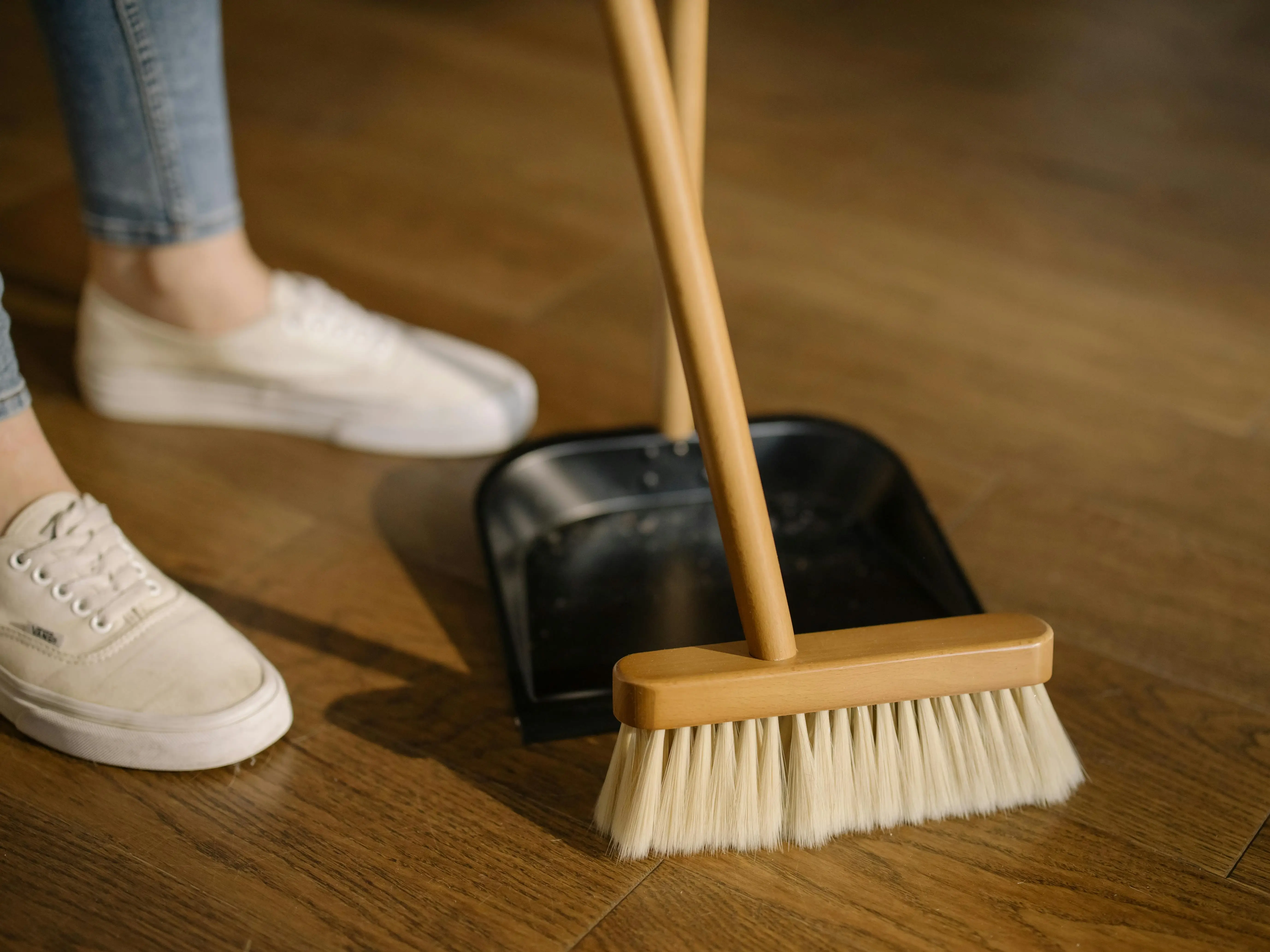 maid in abu dhabi dusting the wooden floor